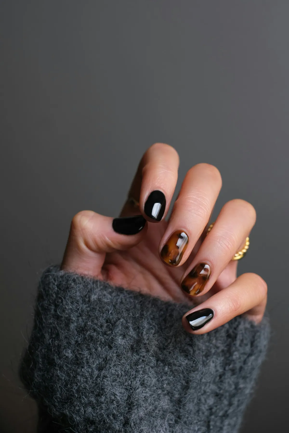 Close-up nail art photo with warm lighting and soft pink tones.